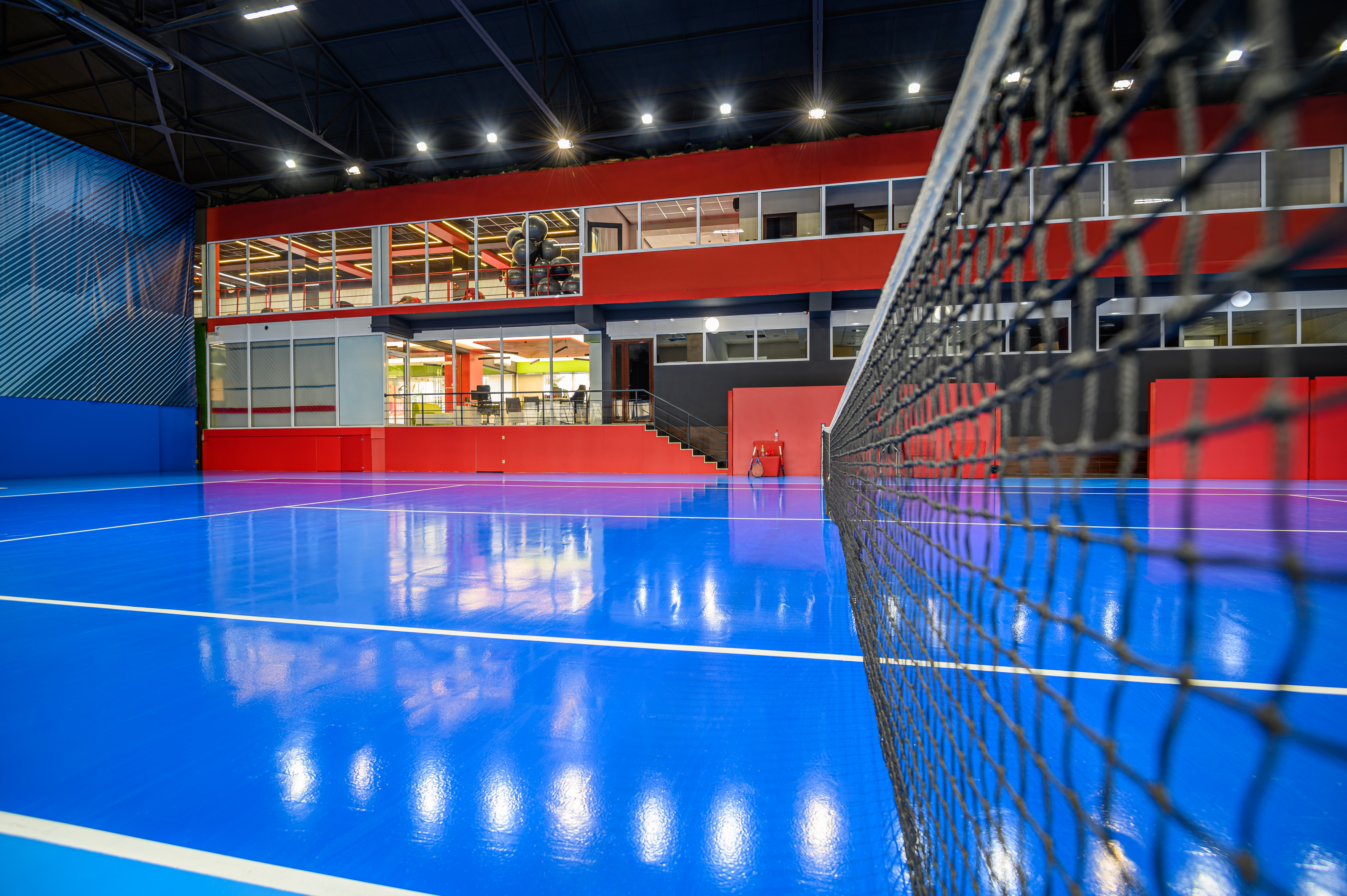 Vibrant blue court in indoor pickleball centres, showing a high-performance commercial sports floor built for durability and safe play.